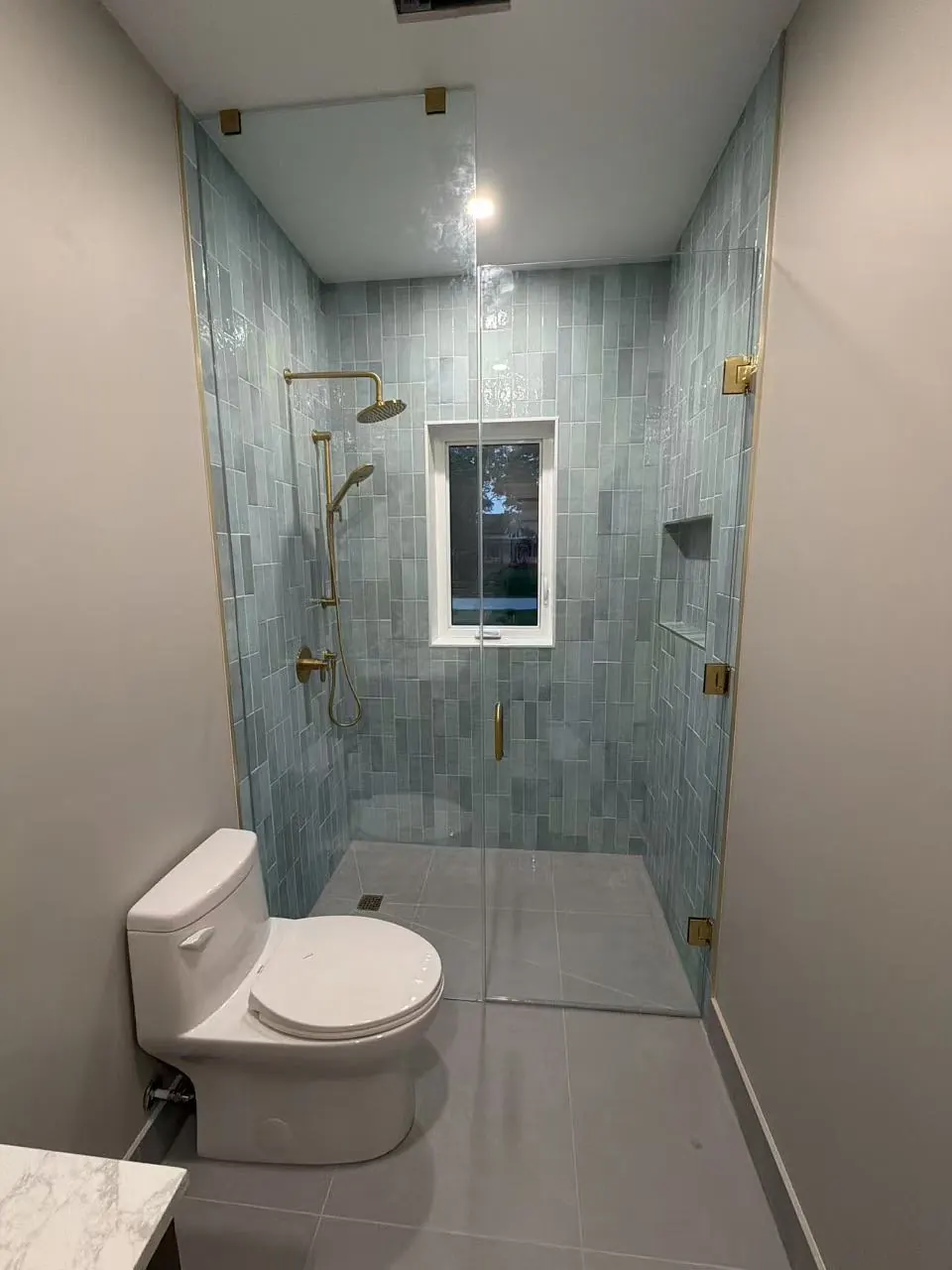 Frameless shower with brass hardware